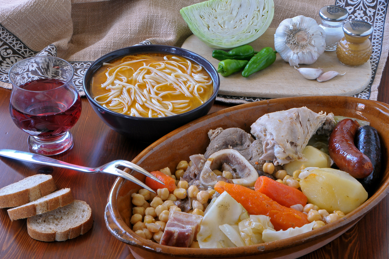 Traditional cocido madrileño served in three courses: noodle broth, chickpeas with vegetables, and meats with sausages Traditional cocido madrileño served in three courses: noodle broth, chickpeas with vegetables, and meats with sausages